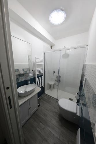 a white bathroom with two sinks and a shower at Villa Serena in Vico Equense