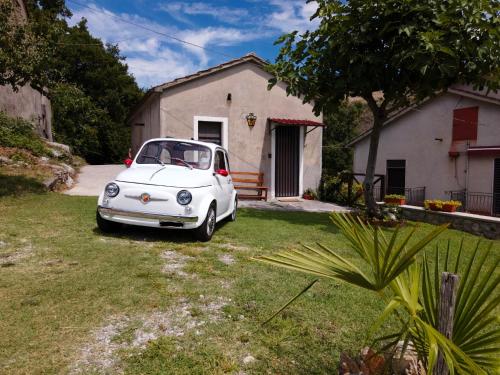 a white car parked in front of a house at Lime House in Lauria