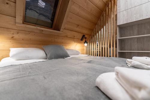 a bedroom with two beds in a wooden cabin at Willa Trawers in Zakopane