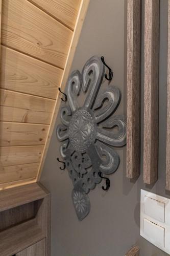 a metal flower on a wall in a room at Willa Trawers in Zakopane