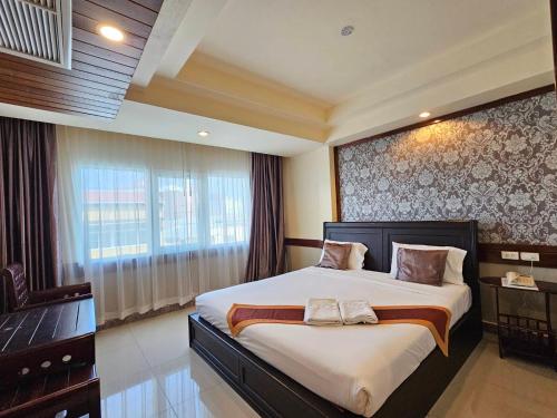 En eller flere senge i et værelse på Boutique Bravo Hotel