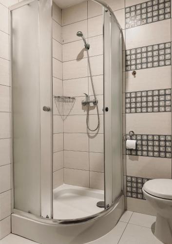 a shower with a glass door in a bathroom at Willa Mia - pokój z prywatną łazienką in Wisła