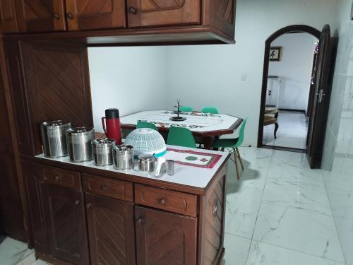 a kitchen with a counter and a table in a room at Casa com Piscina 50000 litros Área Gourmet 3 Suites no Destacado, Bairro mais Nobre de Salinas in Salinópolis