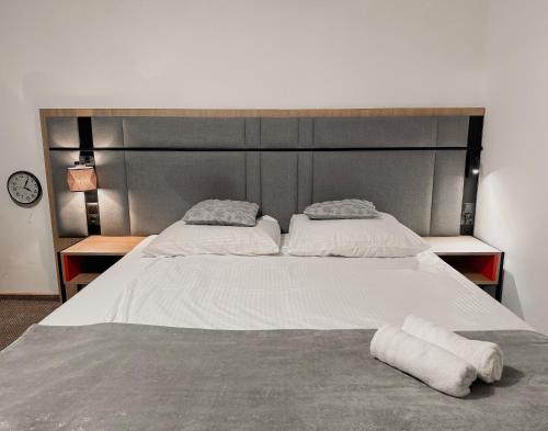 a large bed with two pillows on top of it at Willa Mia - pokój z prywatną łazienką in Wisła