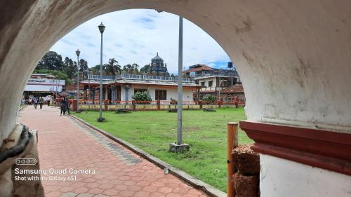 a view of a park from an archway at Varam Homestay in Madikeri