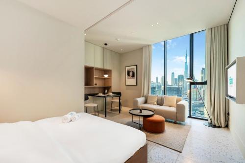 a bedroom with a bed and a living room at Upside Living - City Escape - WFH Friendly-Business Bay in Dubai