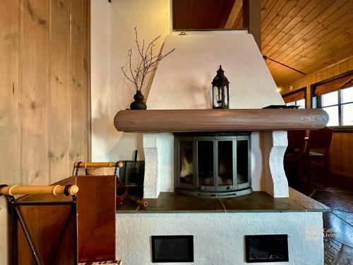 a fireplace in the middle of a living room at Centrally located cottage at Sjusjøen ski center in Ringsaker