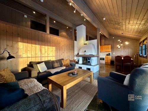 a living room with two couches and a coffee table at Centrally located cottage at Sjusjøen ski center in Ringsaker