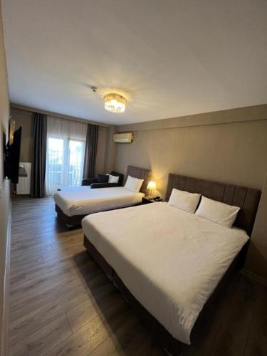a hotel room with two beds and a window at Flower Palace Hotel in Istanbul