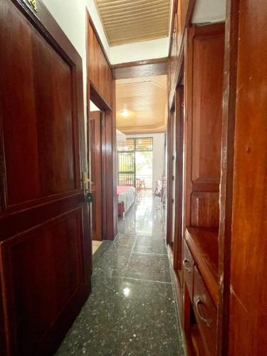 a hallway with wooden doors and a room with a bed at Romantic Getaways in Gitesi