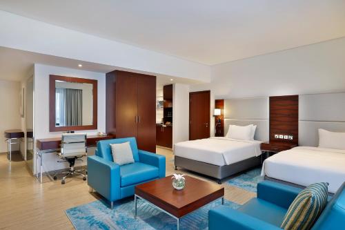 a hotel room with two beds and a desk at Hilton Dubai The Walk in Dubai