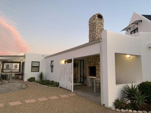 a white house with a pathway leading to the front door at Sea La Vie in Jacobs Bay