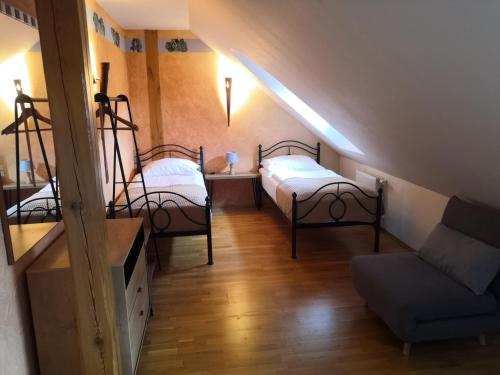 a attic room with two beds and a couch at Boutique Hotel Templ in Mikulov