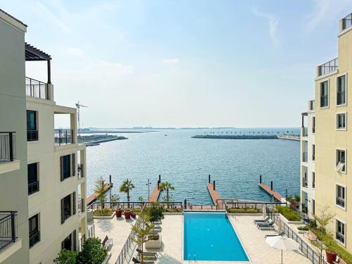 a view of a swimming pool between two buildings at HiGuests - Dream stay in our Cozy 2BR in La Rive Community in Dubai