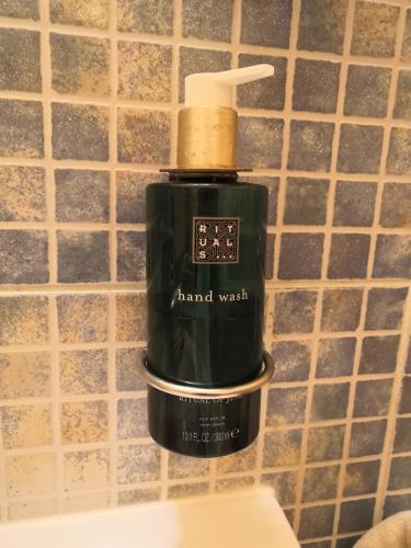 a bottle of hand wash on a bathroom wall at Boutique Hotel Templ in Mikulov