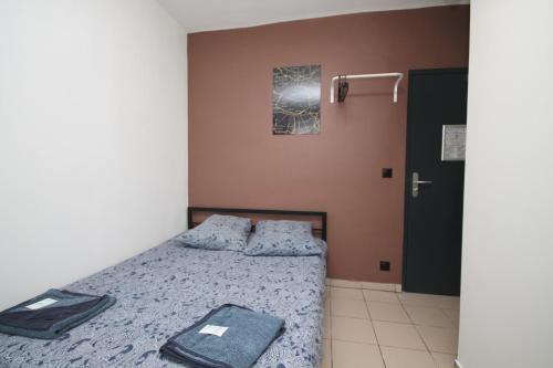 a bedroom with a bed with a blue comforter at 08 - Chambre proche Paris et Transports avec TV WIFI in Saint-Denis