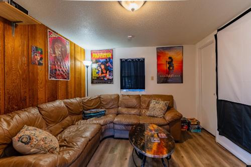 a living room with a couch and a table at Winnemucca Spa - Mountain Home in Cascade-Chipita Park