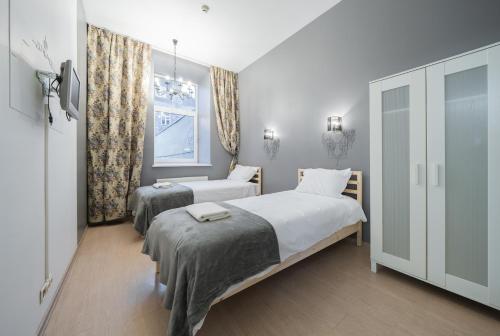 a bedroom with two beds and a window at Halės Self Check-in Guest House - Lollo Stay in Vilnius