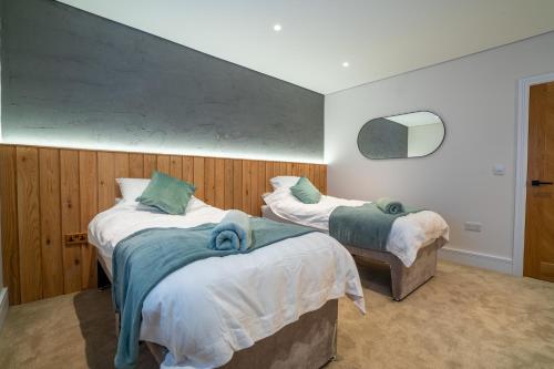 a bedroom with two beds with towels on them at Hazelwick Apartment in Crawley