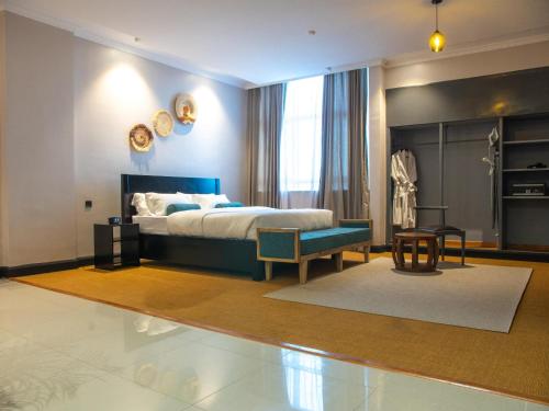 una camera con letto king-size e sedia di Sanna Boutique Hotel ad Arusha
