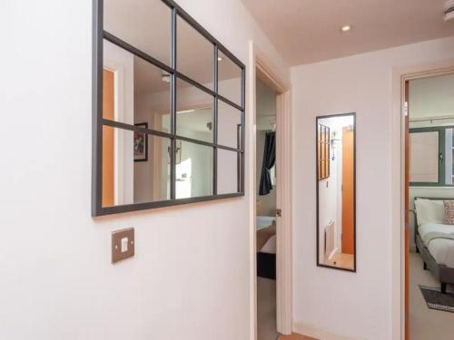 a hallway with a mirror and a bed in a room at Pass the Keys City Centre Retreat close to Christmas Markets in Leeds