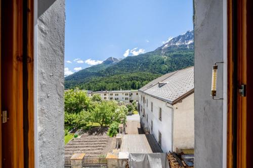 a view from a window of a city with mountains at Chasa Plazza Gronda in Lavin