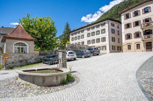 a street in a town with cars parked at Chasa Plazza Gronda in Lavin