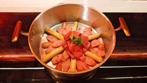 a pot filled with carrots and watermelon and other vegetables at Echarm PLUS International Hotel Zhujiang New Town Wuyangcun Metro Station Branch- Free Deliver Service to Canton Fair Complex During Canton Fair Period in Guangzhou