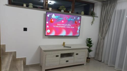 a large screen on a wall with a tv at MONADIN Villa Relax & Spa in Săcele