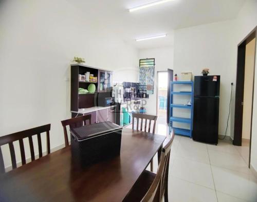a dining room with a table and a refrigerator at Ghumah by R&P (near Hospital Sultanah Bahiyah) in Alor Setar