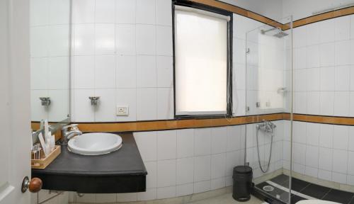 a bathroom with a sink and a window at Firebrick Boutique Residences - GARNET HOUSE in Gurgaon