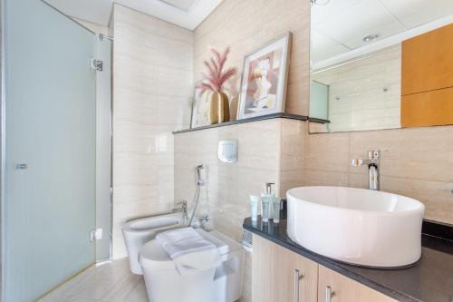 a bathroom with a white sink and a toilet at Frank Porter - Ocean Heights in Dubai