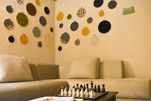 a living room with a couch and a table with bottles at Firebrick Boutique Residences - GARNET HOUSE in Gurgaon