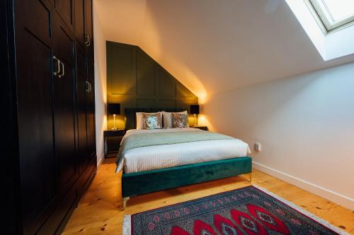 a bedroom with a bed and a large window at Carpathian Loft with Private Parking in Odorheiu Secuiesc