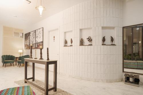 a room with a table with birds on the wall at Firebrick Boutique Residences - GARNET HOUSE in Gurgaon