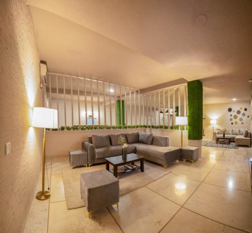 a living room with a couch and a table at Firebrick Boutique Residences - GARNET HOUSE in Gurgaon