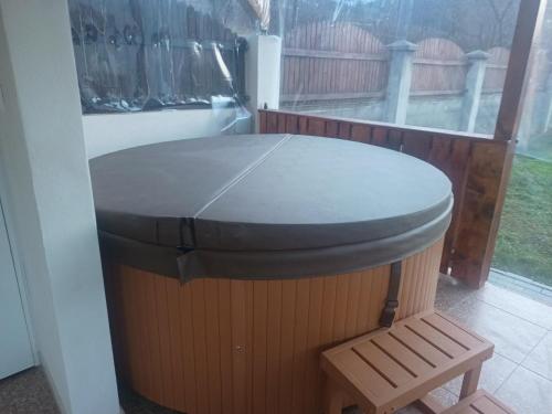 a round table with a stool in a room with a window at MONADIN Villa Relax & Spa in Săcele