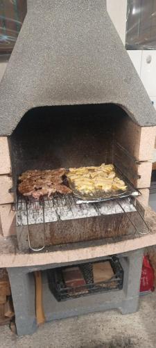 a grill with a bunch of food cooking on it at MONADIN Villa Relax & Spa in Săcele