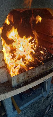 a fire in a pan on a table at MONADIN Villa Relax & Spa in Săcele