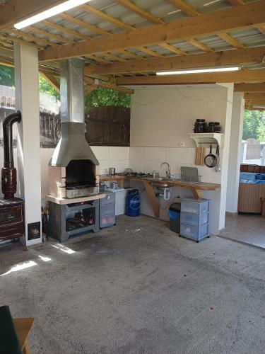 a kitchen with a stove top oven in a garage at MONADIN Villa Relax & Spa in Săcele