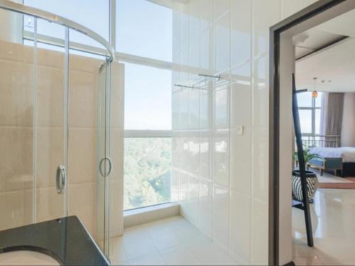 a bathroom with a glass shower with a window at Sanna Boutique Hotel in Arusha