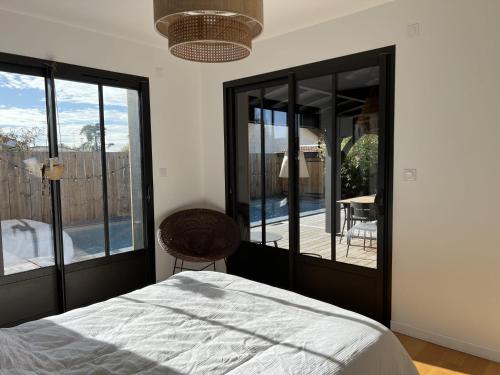 um quarto com uma cama e vista para um pátio em Villa avec piscine chauffée em Arès