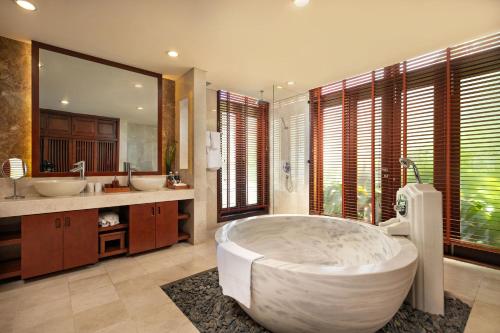 a large bathroom with a large tub and two sinks at Sun Grow Villas in Da Nang