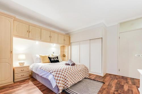 a bedroom with a bed and a large window at Spacious 1 Bed next to Baker St in London