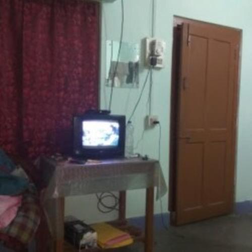 a small television sitting on a desk in a room at Hotel 4-U Assam 