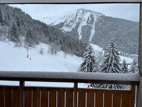 a view of a snow covered mountain from a window at L'orée des pistes in Oz