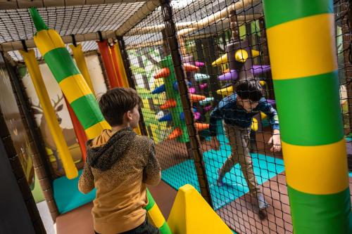 two children playing on a indoor climbing gym at Hotel Der Waldhof in Zell am See