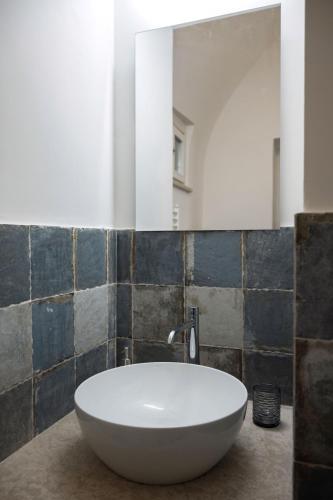 a white tub in a bathroom with a mirror at Gli Arcani in Orvieto