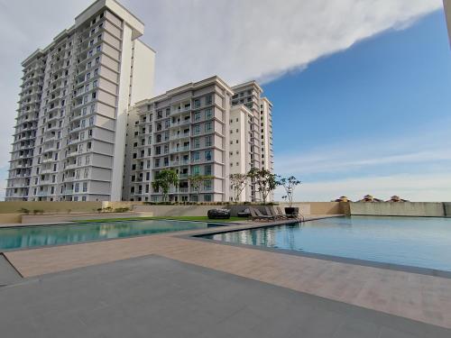 a swimming pool in front of two tall buildings at Paradigm Residence in Johor Bahru