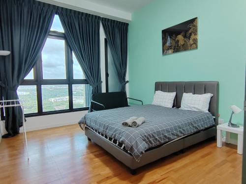 a bedroom with a bed with a teddy bear on it at Paradigm Residence in Johor Bahru